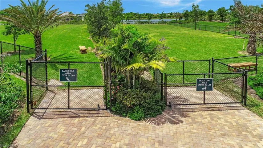 View of gate featuring a lawn