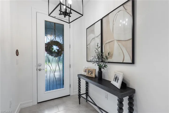Foyer entrance with light tile patterned floors