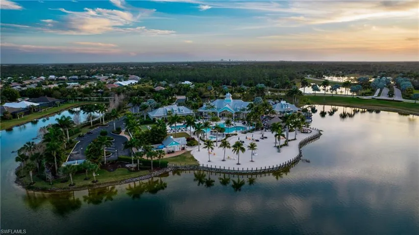 Aerial view at dusk featuring a water view