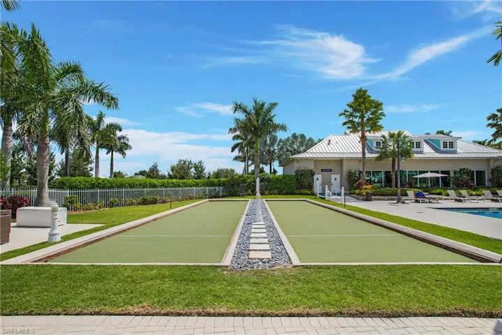 View of home's community with a lawn
