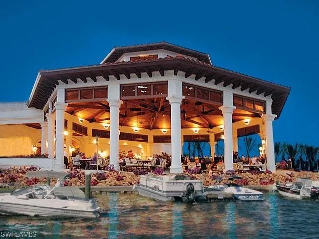 Rear view of property featuring a water view and a patio area