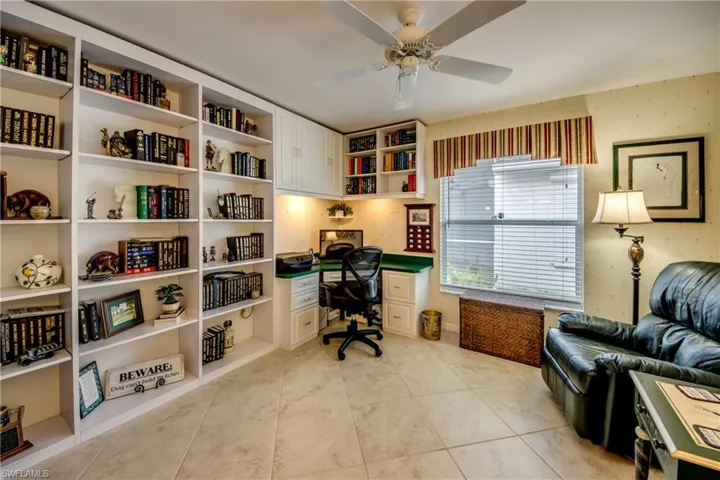 Spacious Den offers lots of storage space.  Bookcases and desk convey with home.