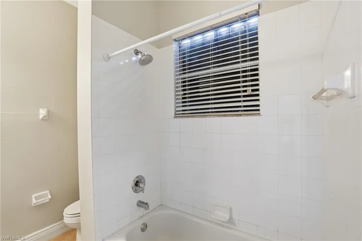 Bathroom with washtub / shower combination and toilet