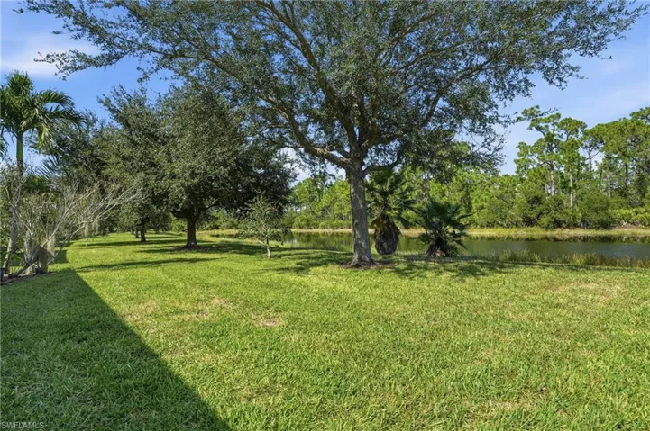 View of green lawn featuring a water view