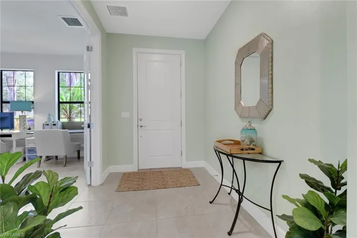 Entryway with light tile patterned floors