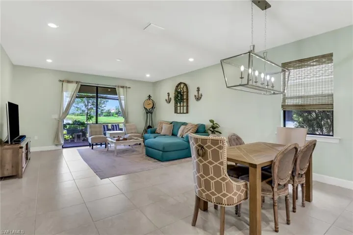 Dining area featuring a notable chandelier and recessed lighting