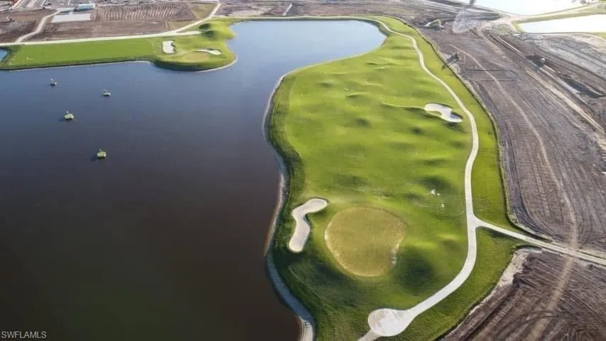 Aerial overview of property's location with a large body of water and a golf course