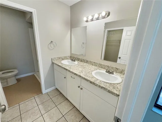 Master bathroom featuring tile patterned floors, vanity, and toilet