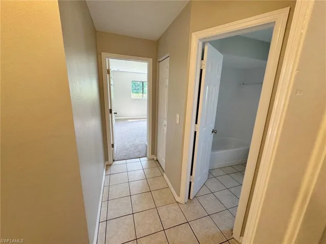 Corridor with light tile patterned floors