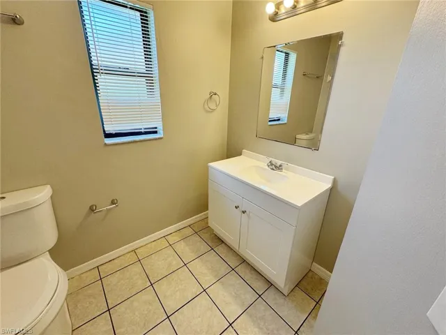 Bathroom with tile patterned floors, vanity, and toilet