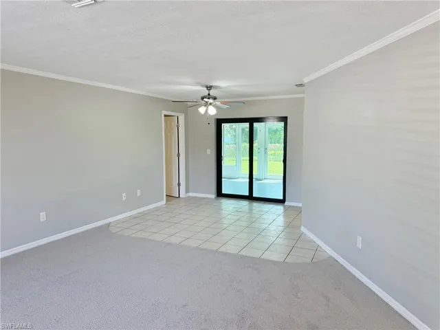 Dining area featuring ceiling fan, crown molding, and light colored carpet