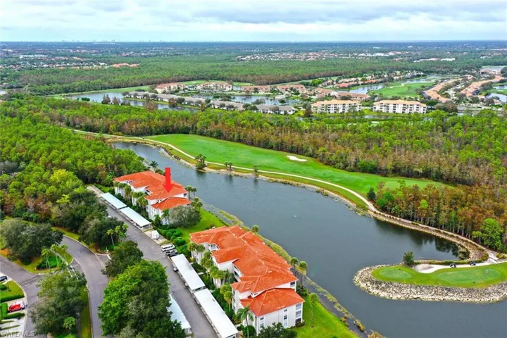 Aerial perspective of suburban area with a local golf course and a nearby body of water