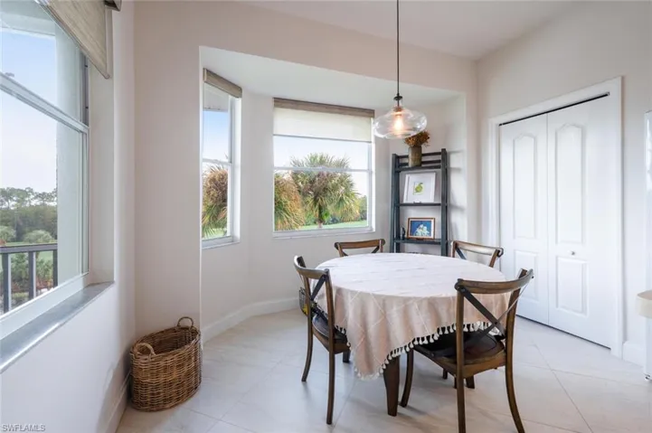 Dining area with light tile patterned floors and baseboards
