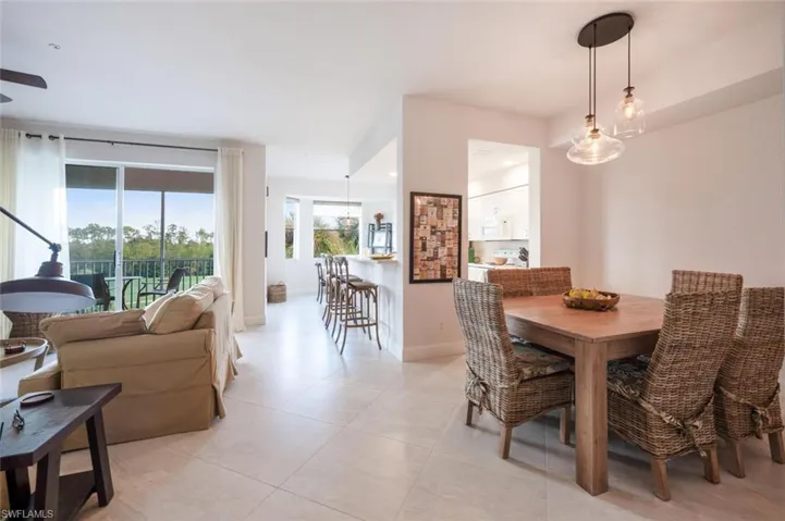 Dining room featuring light tile patterned flooring and baseboards