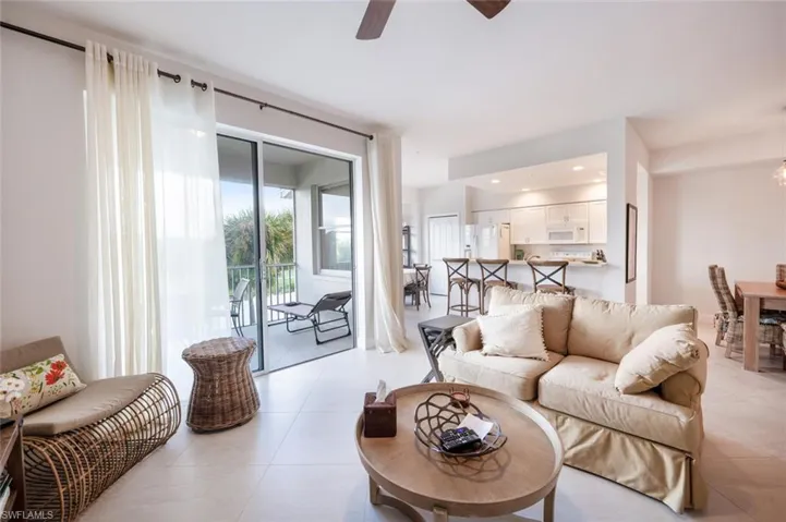 Living room featuring ceiling fan, recessed lighting, and light tile patterned floors