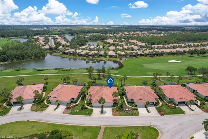 Birds eye view of property with a water view