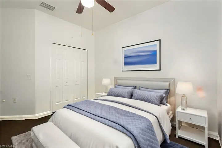 Bedroom featuring dark wood-type flooring, a closet, and ceiling fan