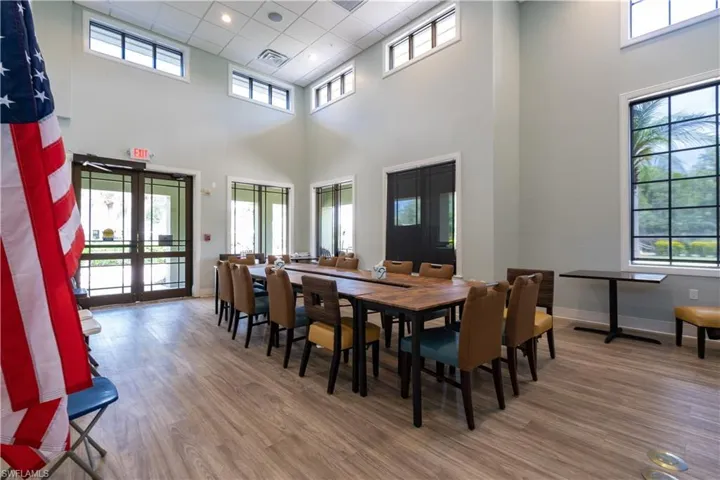 Dining space with a towering ceiling, hardwood / wood-style floors, and french doors