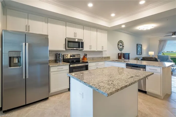 Stainless steel appliances and lovely backsplash create a modern, clean look.