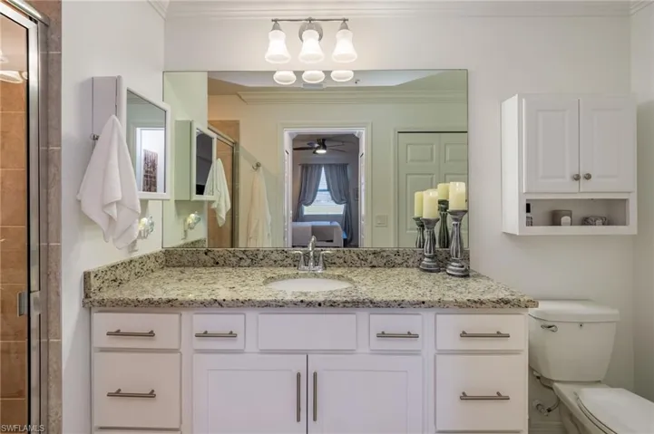 The Primary bathroom includes a walk-in shower and a large vanity with granite countertop.