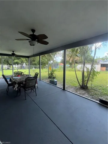 Sunroom with a ceiling fan and outdoor dining space