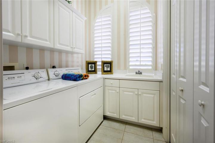 Large Laundry room with Cabinet Storage, tub sink and linen closet