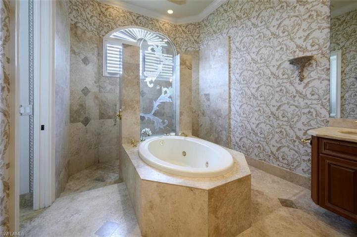 Master Bathroom with open shower , center jetted tub , dual sinks and separate water closet