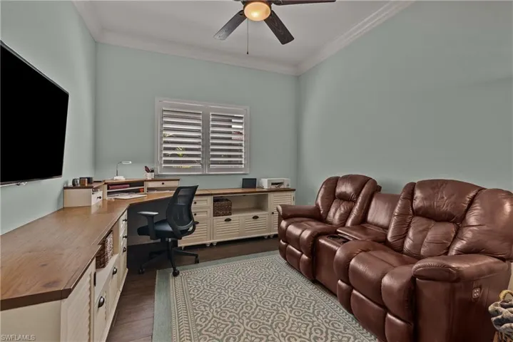 Office space with light hardwood / wood-style floors, crown molding, and ceiling fan