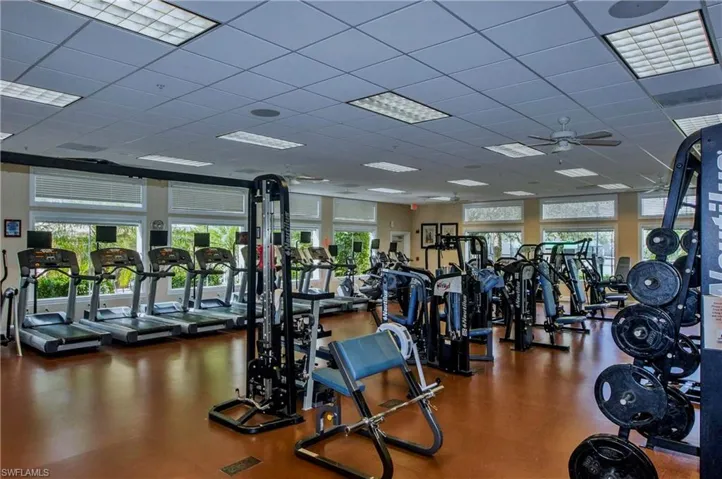 Exercise room featuring a paneled ceiling and ceiling fan