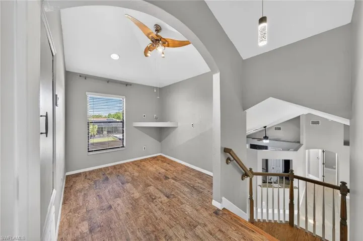 Spare room featuring a ceiling fan and dark wood-style floors