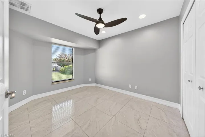 Unfurnished bedroom with a closet, ceiling fan, recessed lighting, and light marble finish flooring