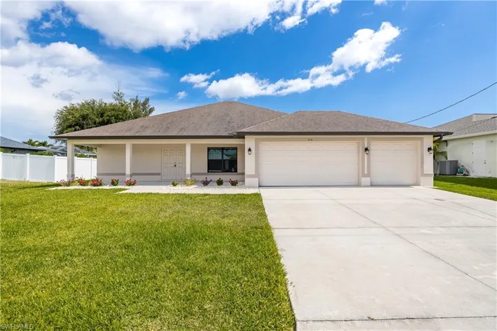 Contemporary single-story residence featuring a two-car garage, concrete driveway, and a covered front porch