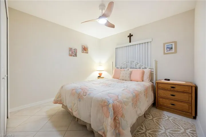 Comfortable bedroom featuring neutral wall tones and tile flooring