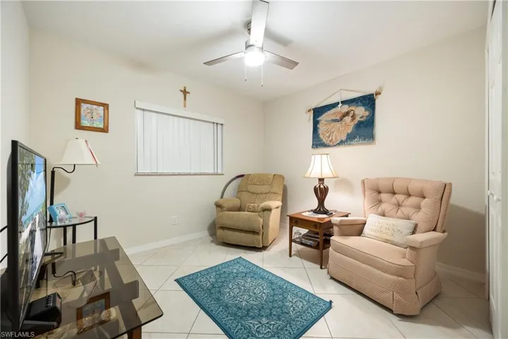 Bright interior space featuring light-toned wall paint and square tile flooring