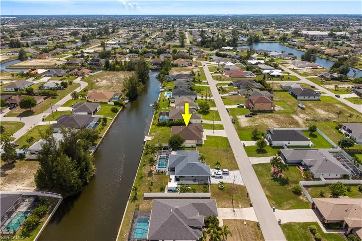 Canal-front property featuring a private dock and direct water access