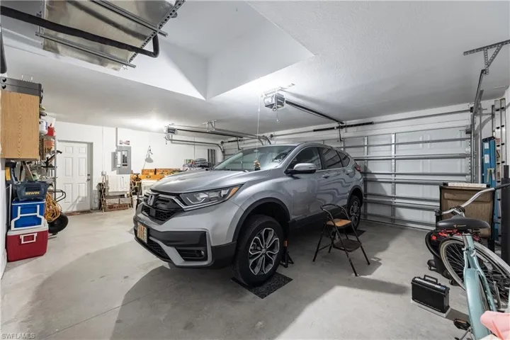 Spacious garage with light gray flooring and white walls