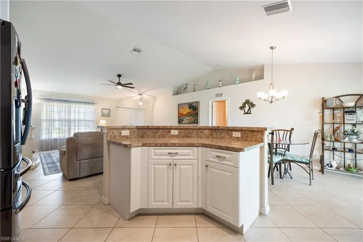 Kitchen island with light-toned cabinetry and granite-finish countertops