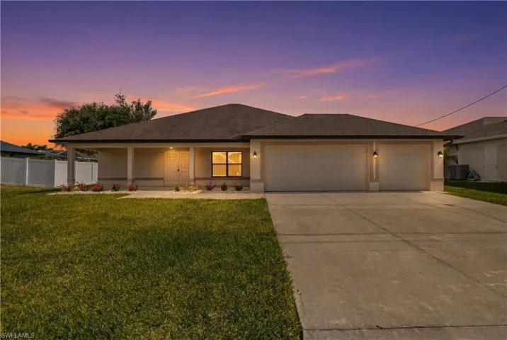 Contemporary single-story residence featuring a two-car garage, covered entry with columns, and a concrete driveway