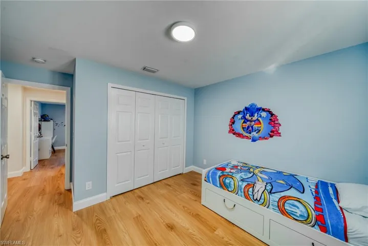 Bedroom featuring light wood-style floors and a closet