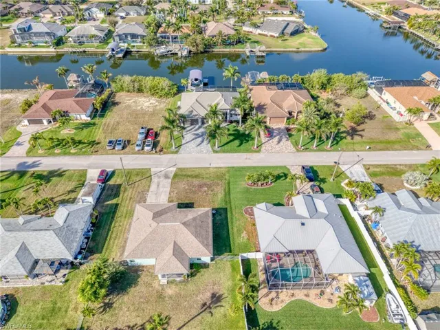 Aerial view of residential area featuring a nearby body of water