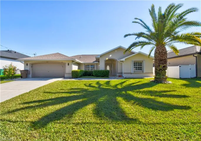 Ranch-style house with stucco siding, concrete driveway, a garage, and a gate