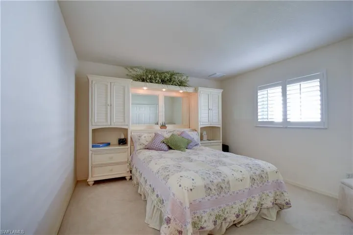 Bedroom featuring baseboards and carpet