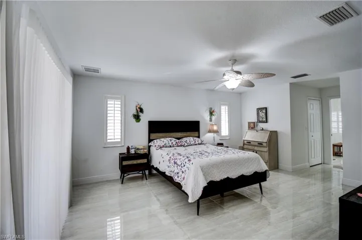 Bedroom featuring multiple windows and ceiling fan