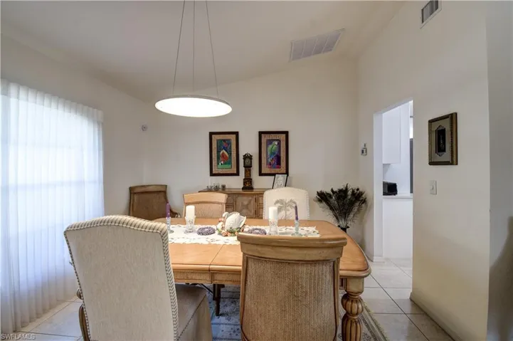 Dining room featuring lofted ceiling and light tile patterned flooring