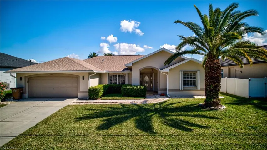 Single story home with stucco siding, driveway, an attached garage, and a shingled roof