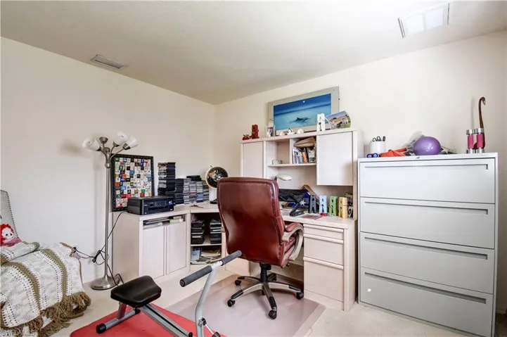 Office area featuring light carpet