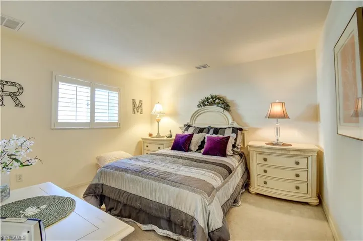 Carpeted bedroom with baseboards