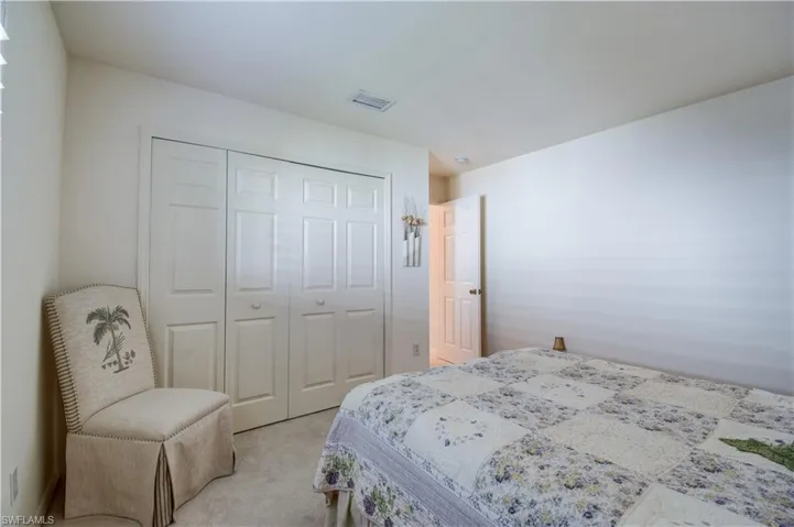 Bedroom featuring carpet and a closet
