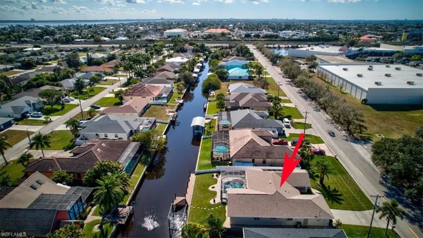 Aerial overview of property's location with a large body of water and nearby suburban area