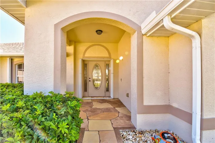 Entrance to property with stucco siding